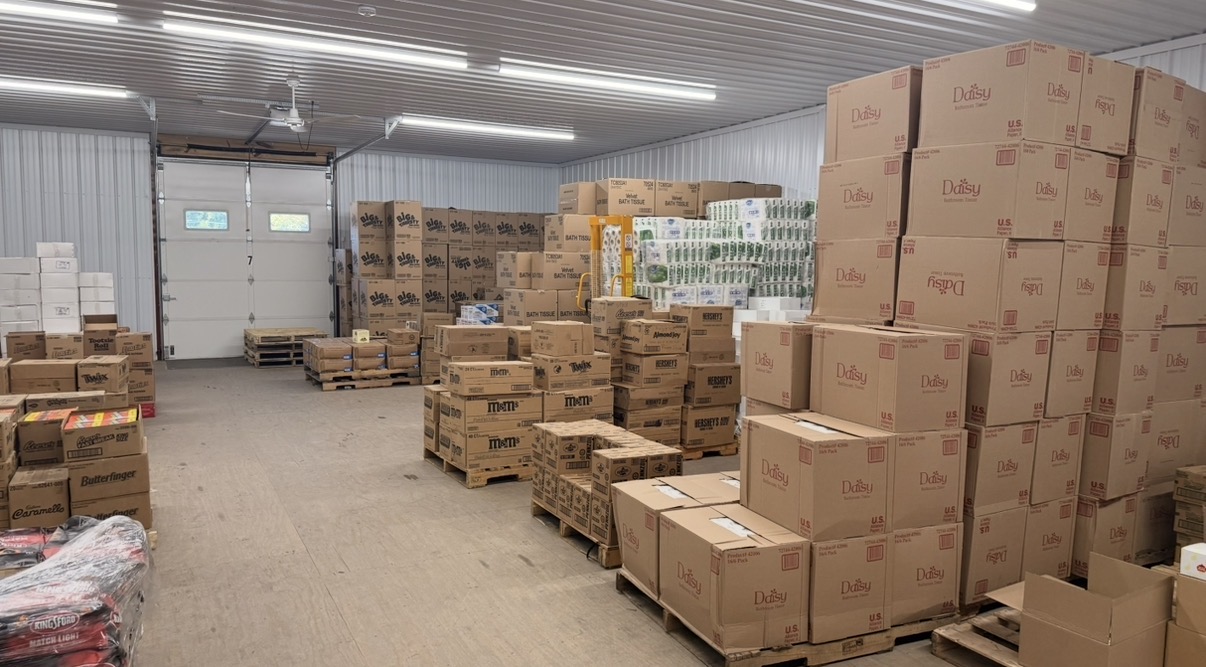 Pallets of paper goods, candy, and store supplies inside the Lambert's warehouse